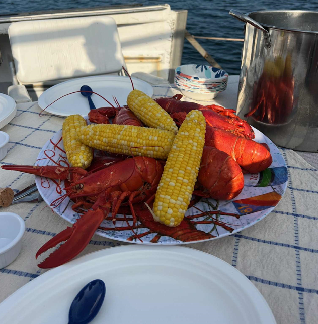 Fresh-caught lobster and raw bar served on the houseboat after hauling